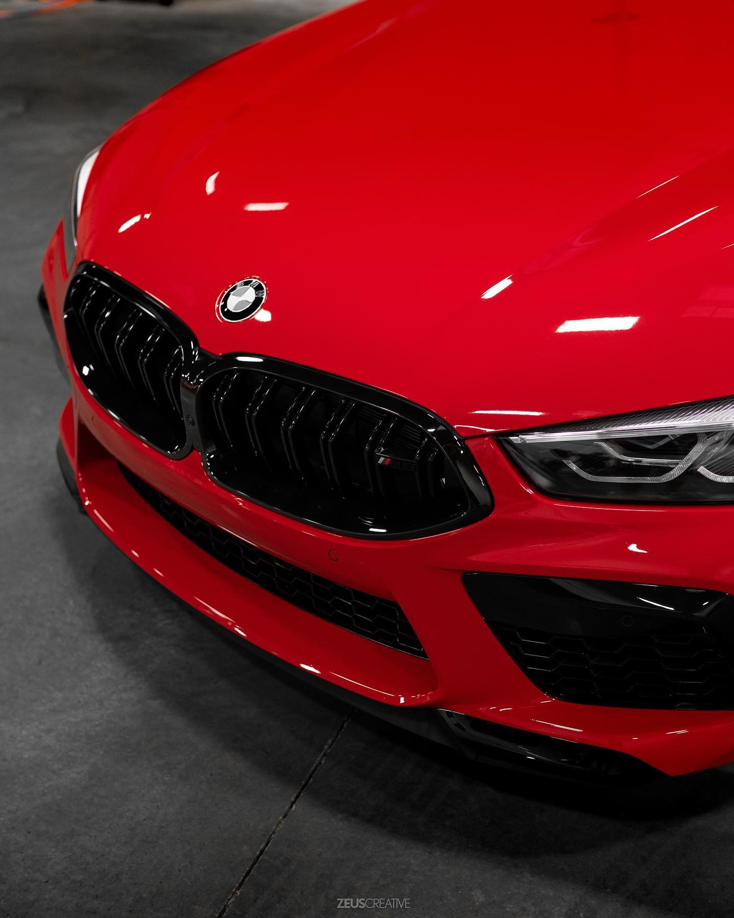 Front detail of a glossy red BMW with ceramic-coated paint protection, photographed at Studio One Protection in Tri-Cities, WA